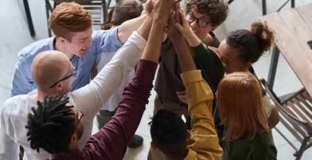 A group of employees holding each other’s hands.