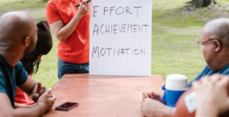 Man speaking to a group of people about team building.