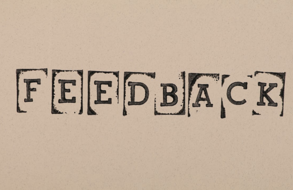 A picture of a stamped text that says “FEEDBACK”.