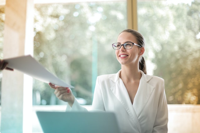 Woman collecting a white folder in her office