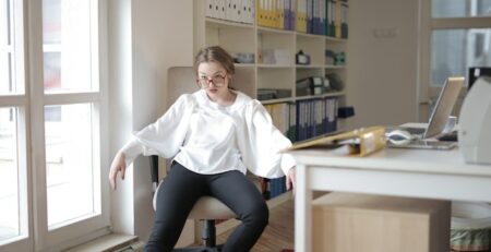 Woman sitting nonchalantly in office