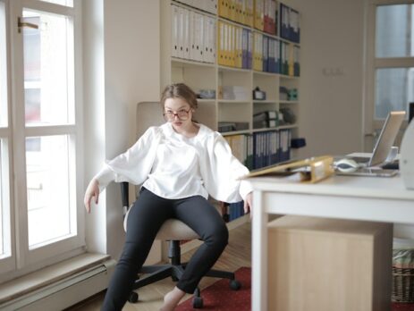 Woman sitting nonchalantly in office