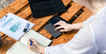 A woman at a desk with her workload.