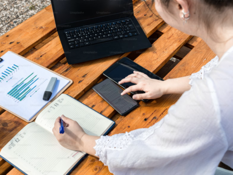 A woman at a desk with her workload.