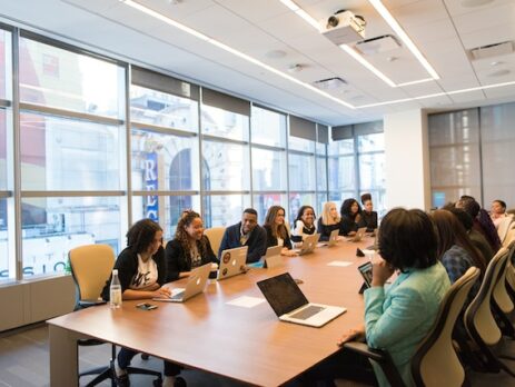 A group of people in a board room.