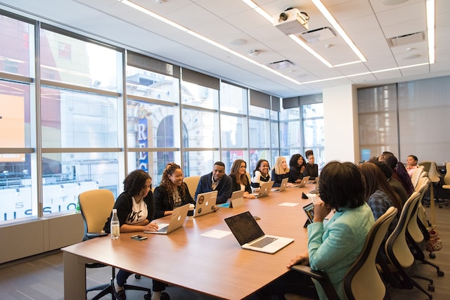 A group of people in a board room.