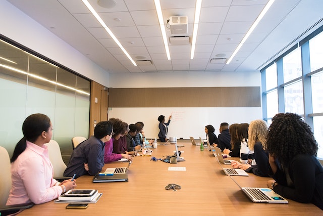 a group of people in a conference room 