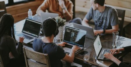 A team of people using laptops