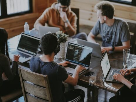 A team of people using laptops