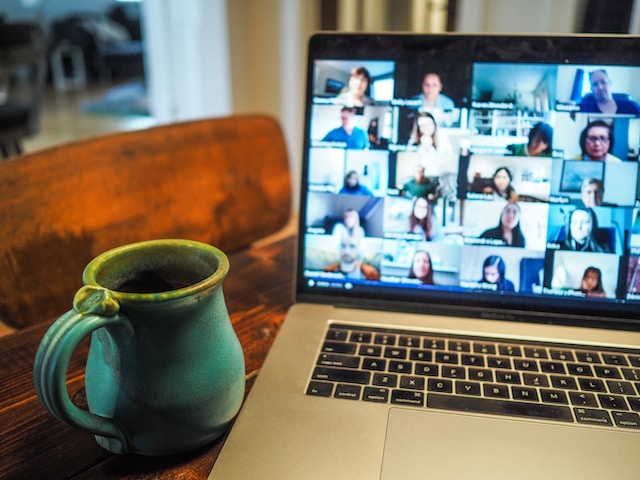 Laptop screen showing a video meeting between a group of people