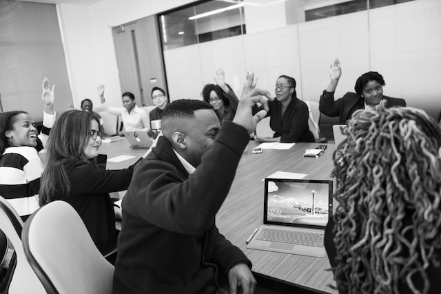 People holding a meeting in a room.