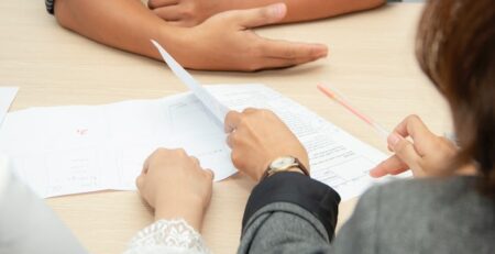 People sitting around a table looking at documents.