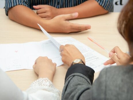 People sitting around a table looking at documents.