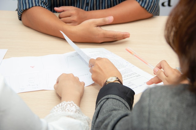 People sitting around a table looking at documents.