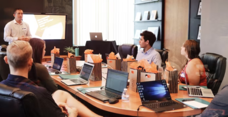 man giving a presentation in a boardroom 