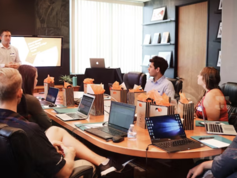 man giving a presentation in a boardroom 