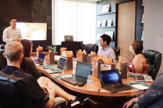 man giving a presentation in a boardroom 