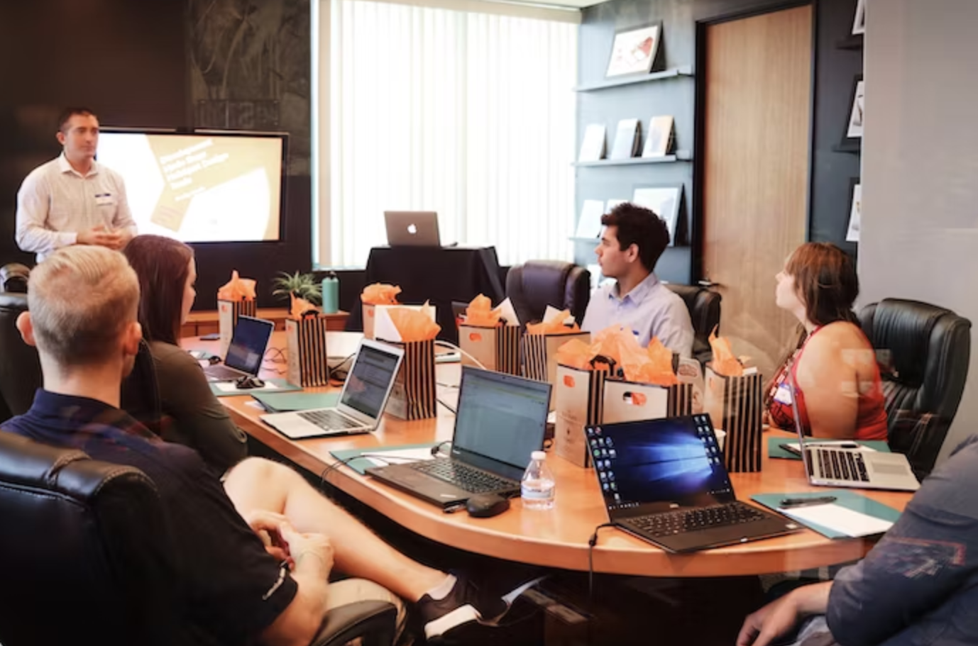man giving a presentation in a boardroom 