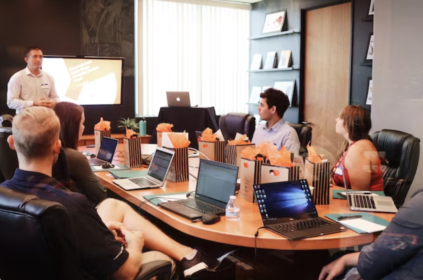 man giving a presentation in a boardroom 