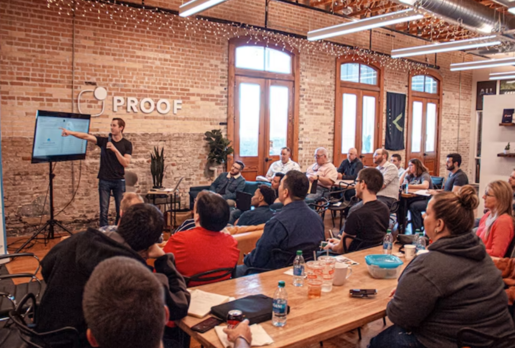 person giving a presentation in a crowded office space