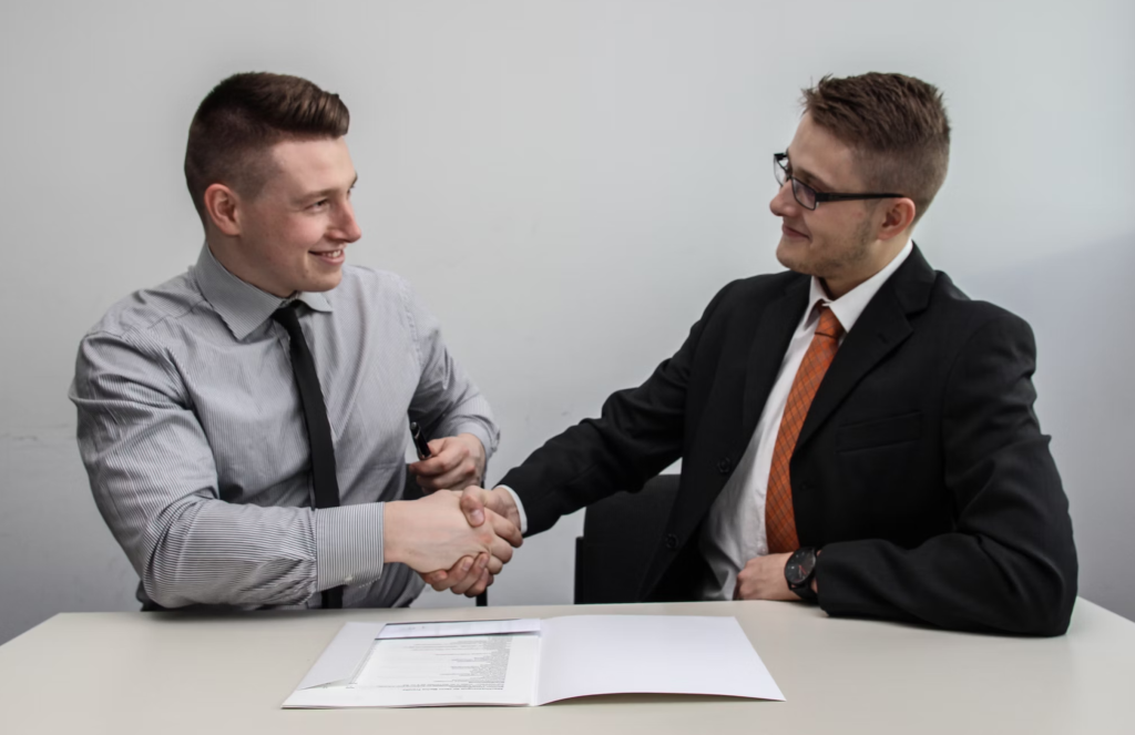 two men shaking hands after business deal