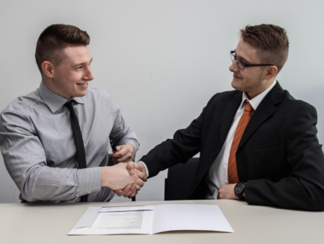 two men shaking hands after business deal 