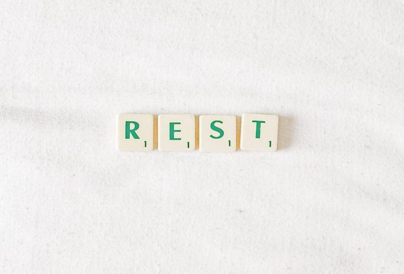 Letter tiles put together to form ‘Rest’.