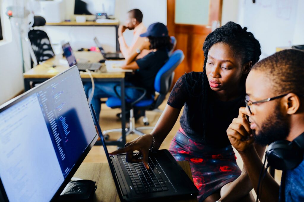 female office staff showing to college something on her monitor