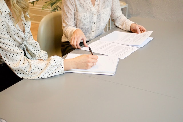 Two women reviewing documents at a table