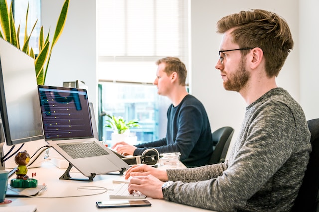 two men working at computers