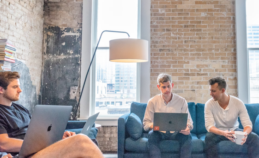 A group of people meeting on couches.