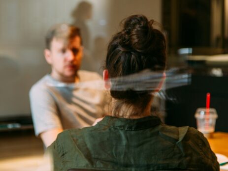 Guy in a office talking to a woman