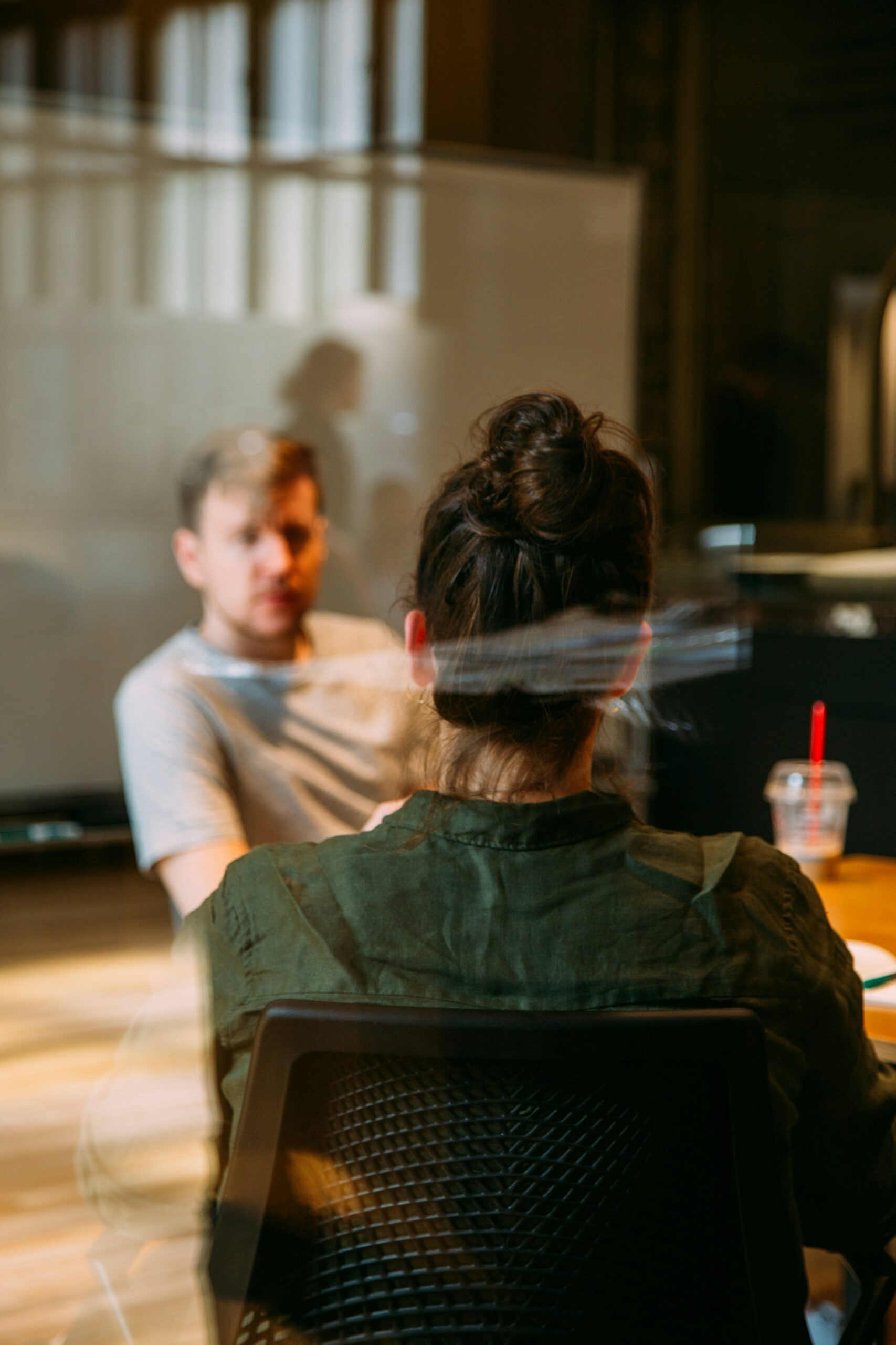 Guy in a office talking to a woman