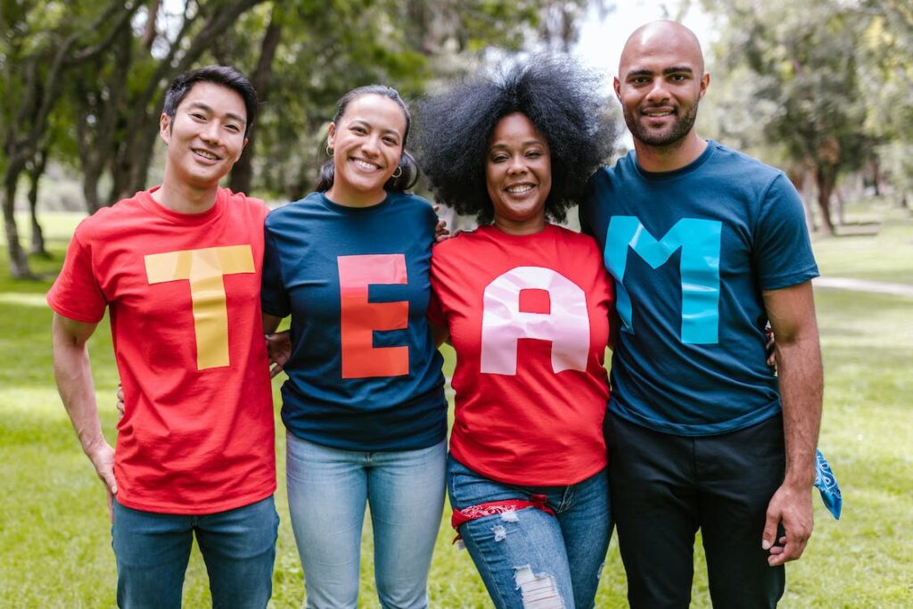 A group of people wearing shirts spelled TEAM