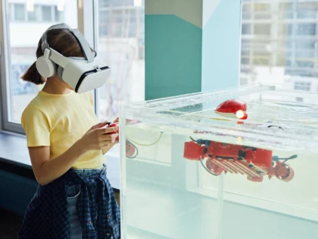 A girl using VR headset testing new device.