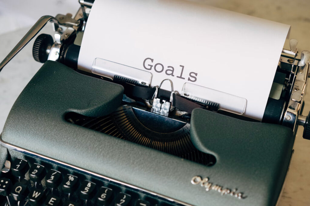 Black and white typewriter with Goals written on paper
