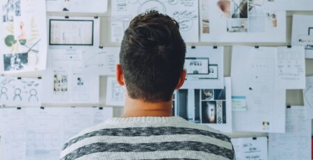 Man looking at vision board for a product.