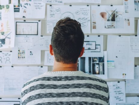 Man looking at vision board for a product.