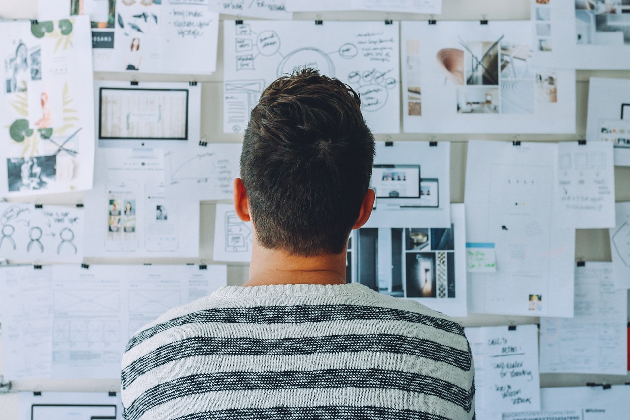 Man looking at vision board for a product.