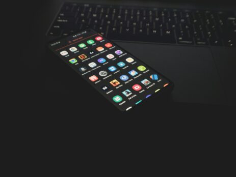 Black iphone on black computer keyboard