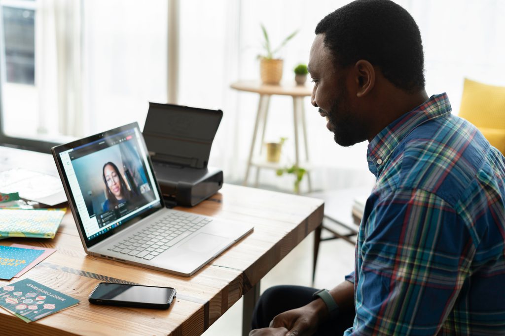 Man in a plaid shirt using macbook pro