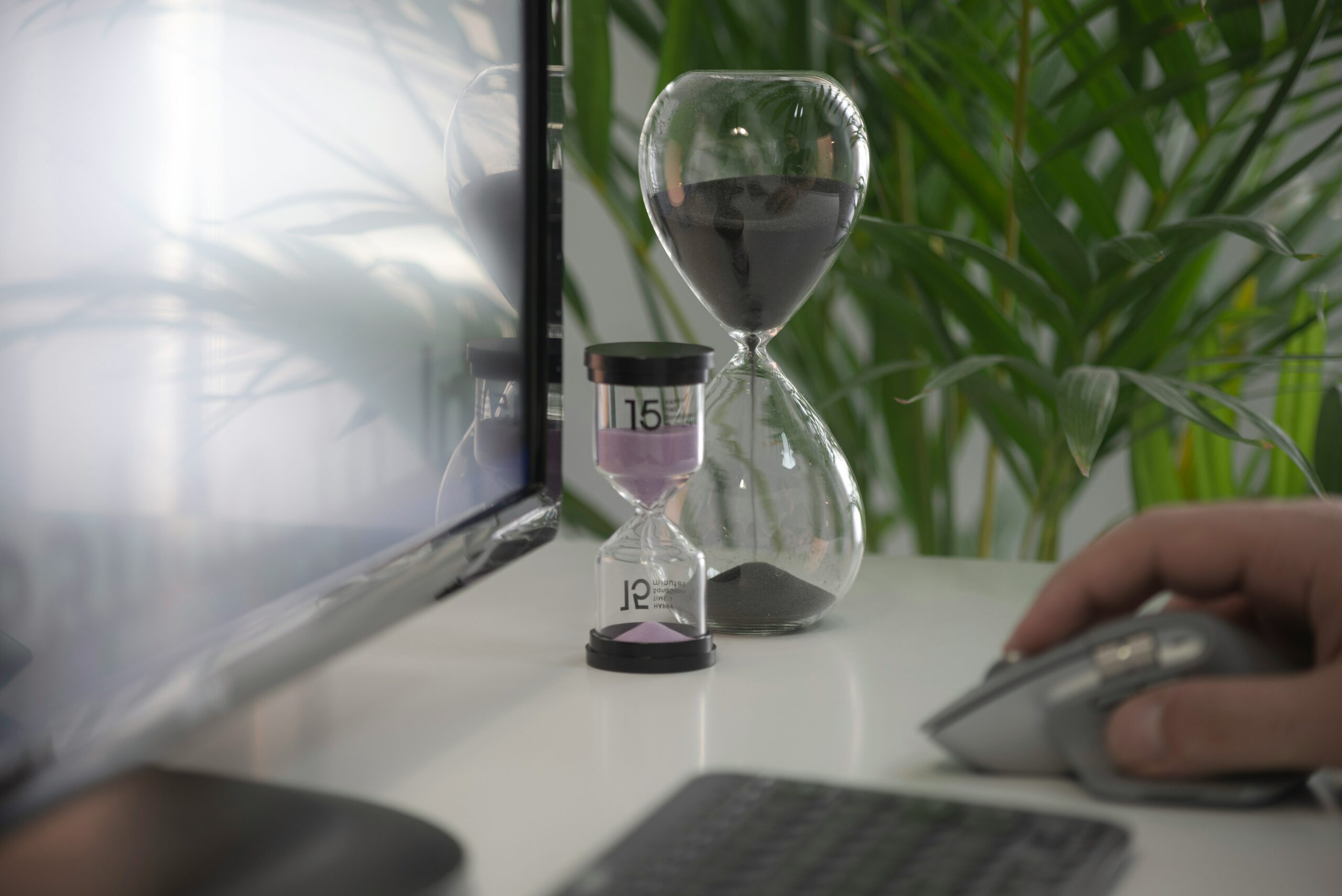 Hourglass in a white business desk.
