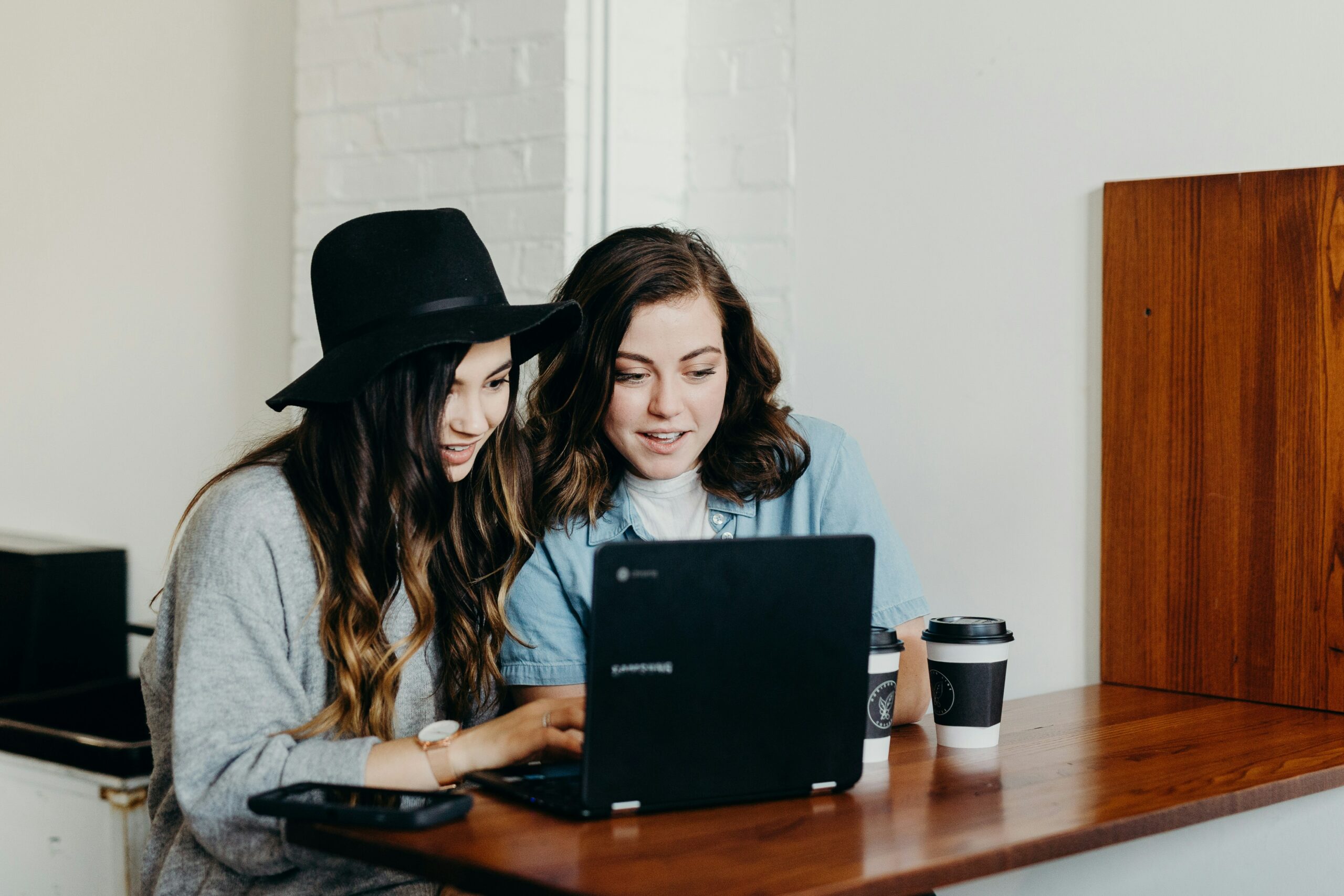 Two women sitting in front of a computer