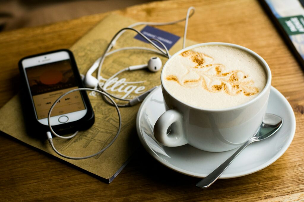 Cappuccino and a phone on a table