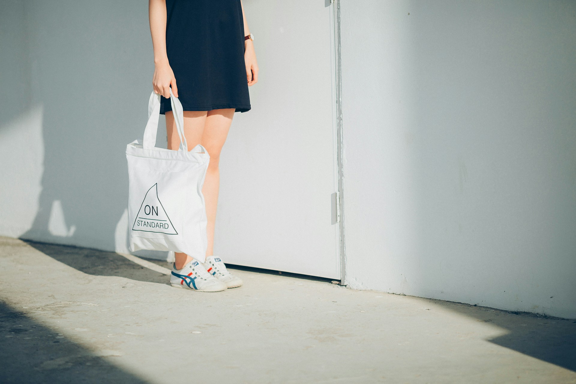 a woman holding a white bag